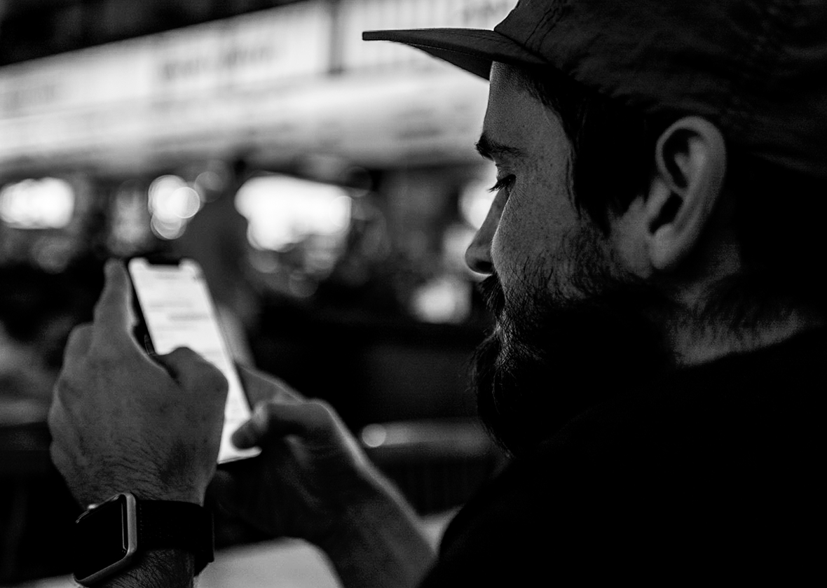 Anton Poliakov looking at a phone on a Kyiv street